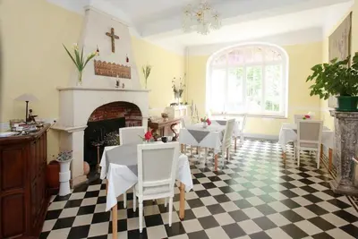 a dining room with a table and chairs and a fireplace at Château de la Prade in Bram
