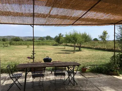 a table with chairs and a vase on top of a field at Domaine Limouzy in Narbonne