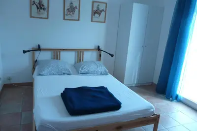 a bedroom with a bed with blue walls and a blue at Bergerie Du Plo in Montlaur