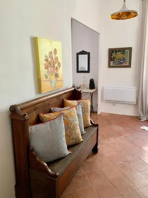 a couch with pillows on it in a room at L'Ancienne Boulangerie in Caunes-Minervois