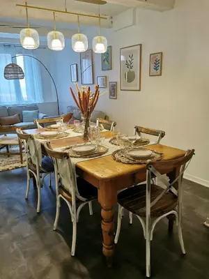 a dining room with a wooden table and chairs at La Caponnière in Carcassonne