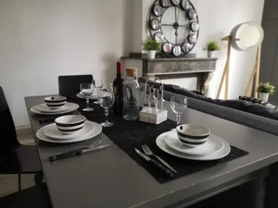 a table with plates and wine glasses on it at Appartement du GET in Revel