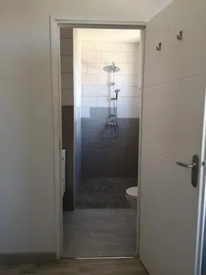 an open door to a bathroom with a toilet at Appartement du GET in Revel