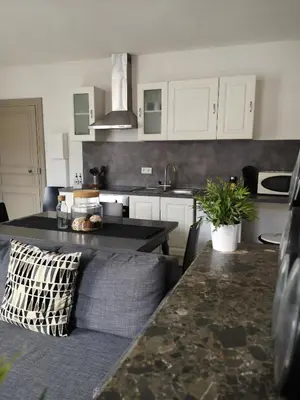 a kitchen with a couch and a table in a room at Appartement du GET in Revel
