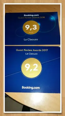 a blue and gold plaque with two clocks on it at La Claouzo in Duilhac