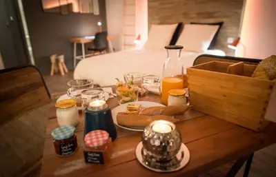 a table with food and drinks on it with a bed at La Maison Gustave in Narbonne