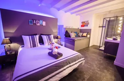 a bedroom with a large bed with two teddy bears on it at La Maison Gustave in Narbonne