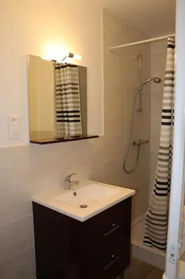 a bathroom with a sink and a shower with a mirror at Etape Cathare in Duilhac