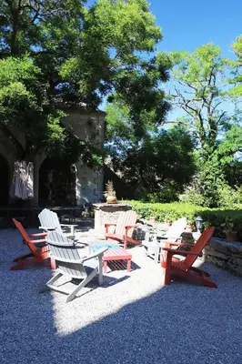 a group of chairs and tables in a yard at Château d'Agel gite in Agel