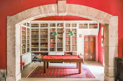 an archway in a room with a pool table at Château d'Agel gite in Agel