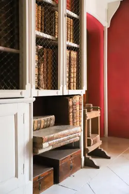 a hutch filled with lots of baskets and books at Château d'Agel gite in Agel