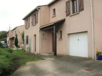a building with two garage doors and a driveway at Les Orchidées in Carcassonne
