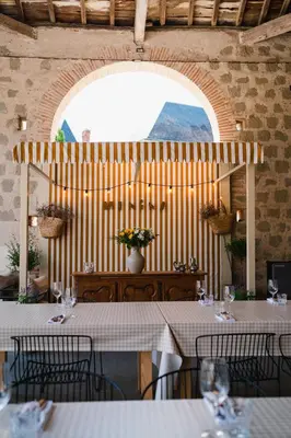 a restaurant with tables and chairs and a large window at Château de la Bousquetarie in Lempaut