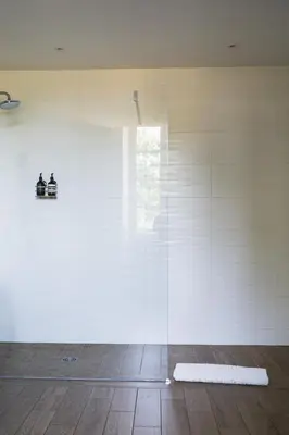a glass wall in a room with a window at Château de la Bousquetarie in Lempaut