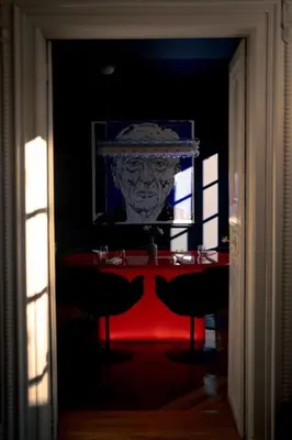 a room with a table with a statue of a head at Château de la Bousquetarie in Lempaut