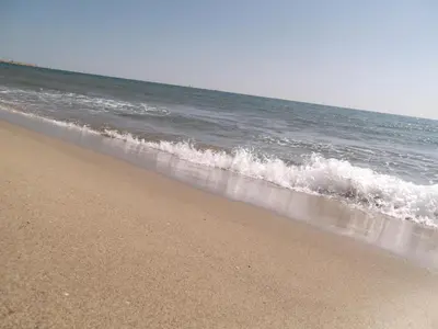 a sandy beach with the ocean in the background at Chouette coquette in Salses-le-Chateau