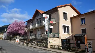 a building on the side of a street at Hotel Bayle in Belcaire