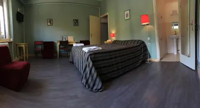 a room with a bed in the middle of a room at Hotel Bayle in Belcaire