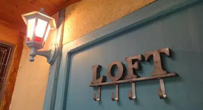 a sign on the side of a door with a light at Riverside Home Cottage in Trèbes