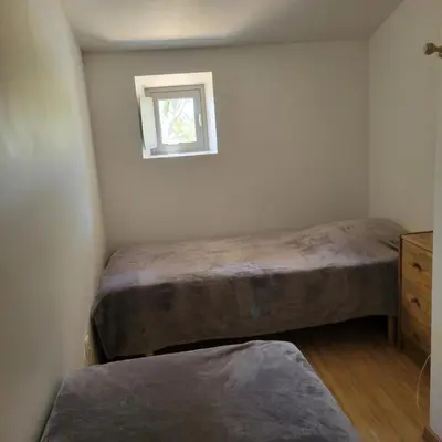 a bedroom with two beds and a window at Les Fenals in Fitou