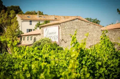 a building with a sign on the side of it at Les Fenals in Fitou