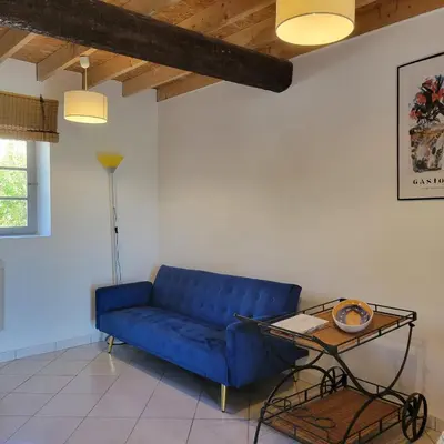 a blue couch in a living room with a table at Les Fenals in Fitou