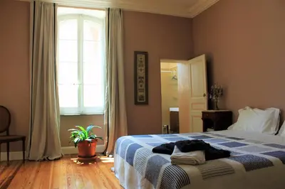 a bedroom with a blue and white bed with a window at B&B Coup de Coeur in Bram