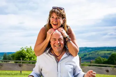 a woman is sitting on top of a man at Le Clos des Troubadours in Pennautier