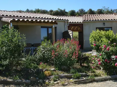 a house with some flowers in the yard at gîtes 