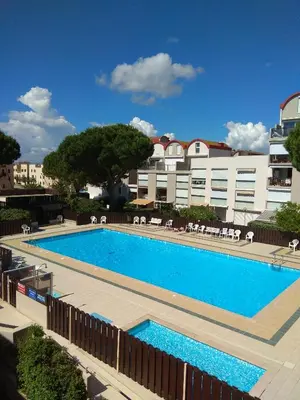 a large swimming pool in front of a building at Studio La Presqu'île 2 in Gruissan