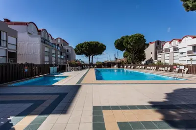 a swimming pool in the middle of a building at Studio La Presqu'île 2 in Gruissan