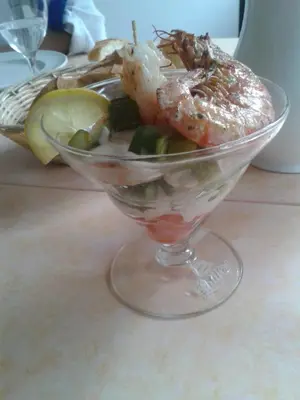 a glass bowl of shrimp and vegetables on a table at Le Baudilois in Pont-de-Larn