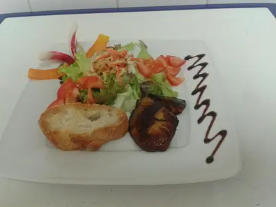 a plate of food with a salad and a sandwich at Le Baudilois in Pont-de-Larn