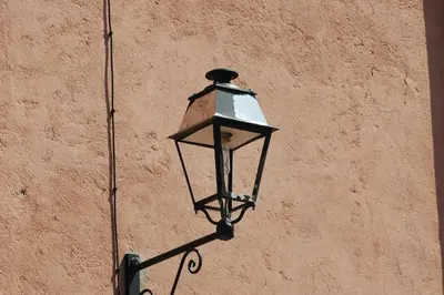 a street light attached to the side of a building at Petite Chouette in Salses-le-Chateau