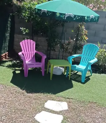 two chairs and a table in a yard at Petite Chouette in Salses-le-Chateau
