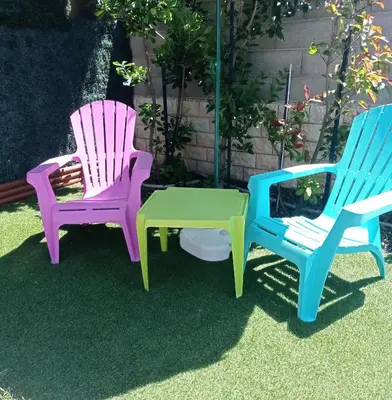 three chairs and a table in a yard at Petite Chouette in Salses-le-Chateau