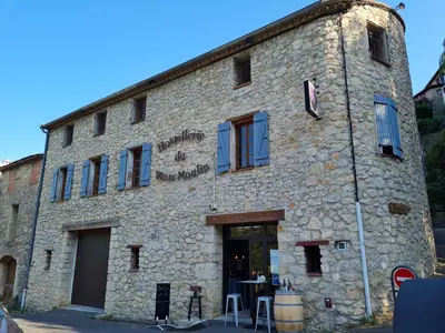 a large stone building with a door in front at Hostellerie du Vieux Moulin in Duilhac