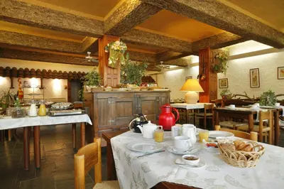 a kitchen with a table with food on it at Logis Hôtel Cartier in Quillan