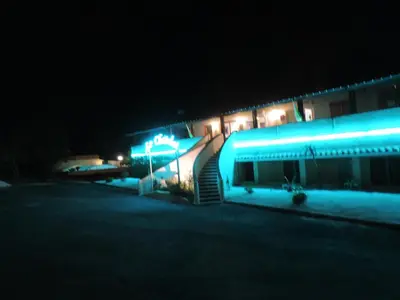 a building with blue lights on it at night at Hôtel Restaurant Mas Le Châtelet in Saint-Paul-de-Fenouillet