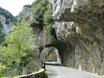 a mountain road with a tunnel on the side at Hôtel Restaurant Mas Le Châtelet in Saint-Paul-de-Fenouillet