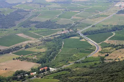 an aerial view of a green field with a road at Hôtel Restaurant Mas Le Châtelet in Saint-Paul-de-Fenouillet