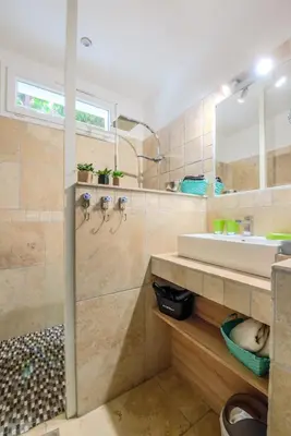 a bathroom with a sink and a mirror at Les Gîtes de Nathalie: Corneille et Rivals in Carcassonne
