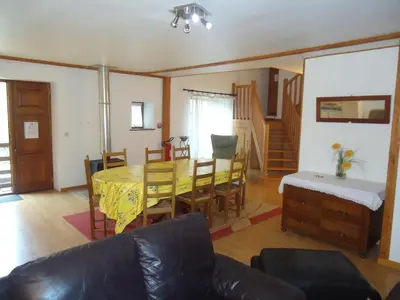 a living room with a dining room table and chairs at Domaine de la Pinsonnière in La Livinière