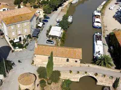 an aerial view of a city with a river at Le Neptune in Le Somail