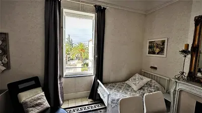 a bedroom with a bed and a window at Le Neptune in Le Somail