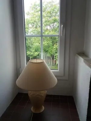 a lamp sitting in front of a window at Apartment Albert parking privé gratuit in Limoux