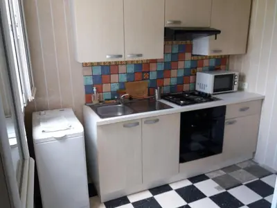 a small kitchen with a sink and a stove at Apartment Albert parking privé gratuit in Limoux