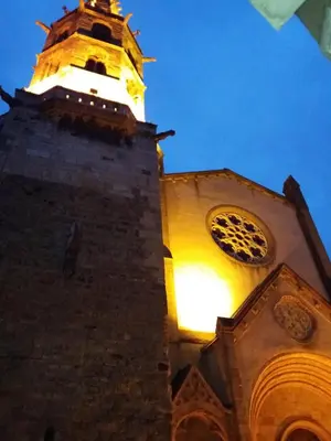 a tall tower with a clock on top of it at Apartment Albert parking privé gratuit in Limoux