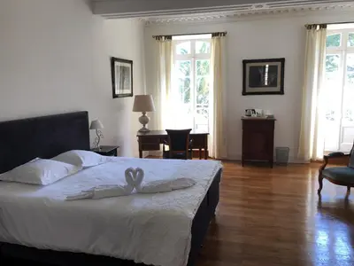 a bedroom with a bed with two white towels on it at Le Jardin d'Homps in Homps
