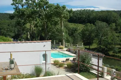a villa with a swimming pool in a garden at Les Jardins de Soulane B&B - Adults only in Belcastel-et-Buc
